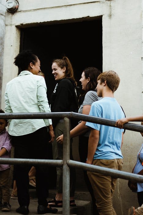 People waiting in line on a staircase.