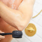 AT-4003-EBlack?Man using black PMD Clean Body exfoliator attachment to scrub elbow in shower